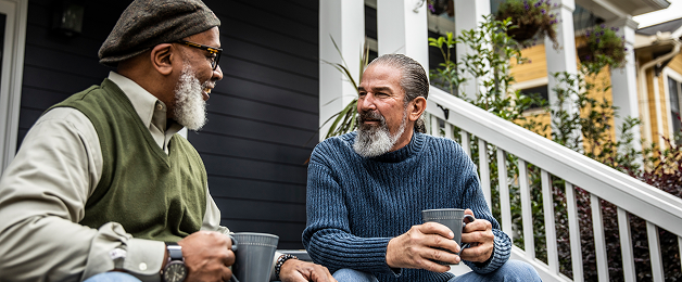 Actor portrayal of two elderly men having coffee together