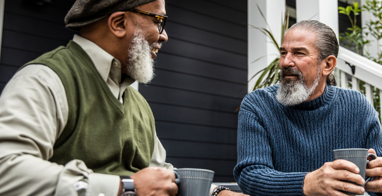 Actor portrayal of two elderly men having coffee together