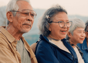 Actor portrayal of a group of elderly people in a mountainous setting