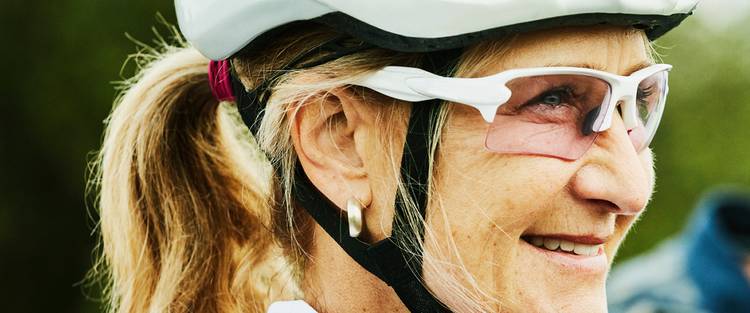 Actor portrayal of an elderly woman wearing a bike helmet