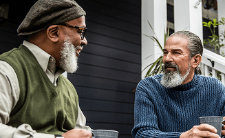Actor portrayal of two elderly men having coffee together