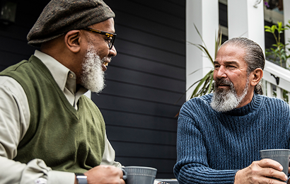 Actor portrayal of two elderly men having coffee together