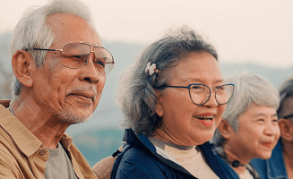 Actor portrayal of a group of elderly people in a mountainous setting